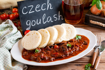 Beef goulash, soup and a stew, made of beef chuck steak, tomatoes, onion, pepper and plenty of paprika. Hungarian traditional meal. Traditional Czech dish