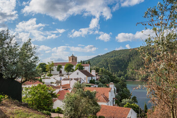 Fototapeta na wymiar Landscape with houses next to the river Zêzere and the templar tower of Dornes, PORTUGAL
