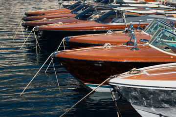 Few luxury retro motor boats in row at the famous motorboat exhibition in the principality of...