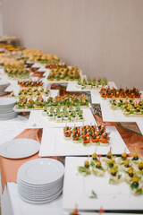 buffet for a celebration filled with food, sandwiches, tartlets, snacks