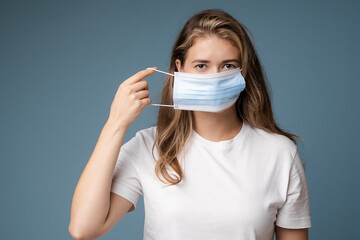 Woman looks sick wearing protection face mask.