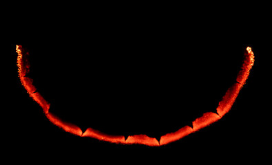 burning paper, glowing edge of paper on a black background