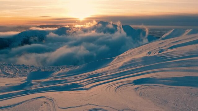 Sunrise over winter mountains landscape with beautiful snowdrift structure, outdoor adventure background