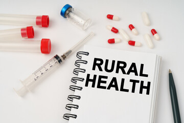 On the table are pills, injections, a syringe and a notepad with the inscription - rural health