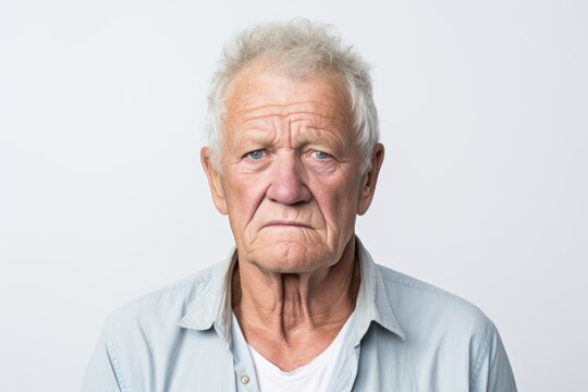 Portrait of a sad senior man. Isolated on white background.