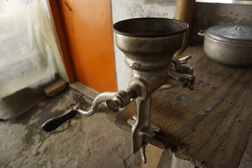 Traditional coffee mill attached to a wooden table on a coffee farm close to Salento, Eje Cafetero,...