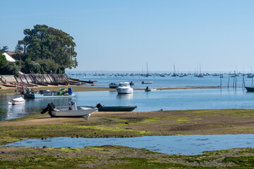 Obraz premium Beach houses in Arcachon Bay with many fisherman's boats and oysters farms, Cap Ferret peninsula, France, southwest of Bordeaux along France's Atlantic coastline