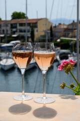 Glasses of cold rose Cote de Provence wine in yacht harbour of Port Grimaud, summer vacation on French Riviera in Provence, France