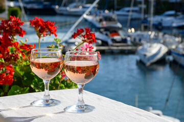 Glasses of cold rose Cote de Provence wine in yacht harbour of Port Grimaud, summer vacation on...