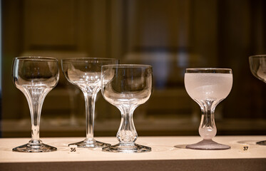 Old and vintage collection of empty wine or champagne bubbles wine glasses on display