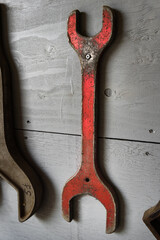 Red Wrench/Spanner and Other Tools on Wall