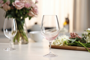 Plain clear wine glass mockup on wedding floral background. Generative AI