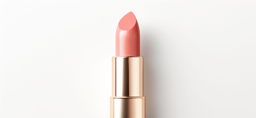 An peach fuzz color lipsticks top in a golden case on a white background. Make up a product show off. Copy space. - obrazy, fototapety, plakaty