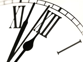 Macro of roman numerals clock at almost 12 o clock