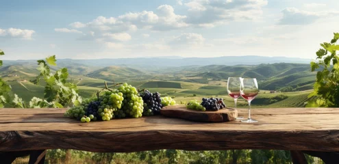 Poster table with wine and fruit on the ground overlooking a vineyard © olegganko