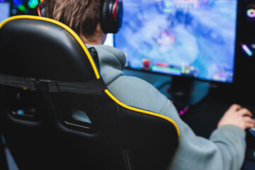 Cyber sport e-sports tournament, team of professional players, gamers playing online championship in competitive moba, strategy fps game in a cyber games arena club, person in a chair with pc - obrazy, fototapety, plakaty