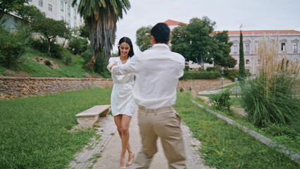 Passionate lovers dancing park alley. Energetic pair moving salsa choreography