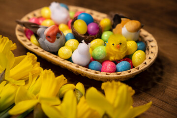 Easter floral colorful eggs composition with chick, rabbit, bird on wooden table