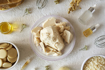 Shea butter with beeswax, essential oil and cocoa butter - ingredients for homemade cosmetic cream
