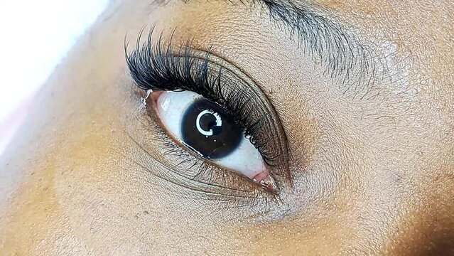 close up of eyelash extensions in beauty salon macro eye ,2d volume 3d volume,russian volume, classical style, remover,patches,lash technician,beautician,lashmaker,cat eye