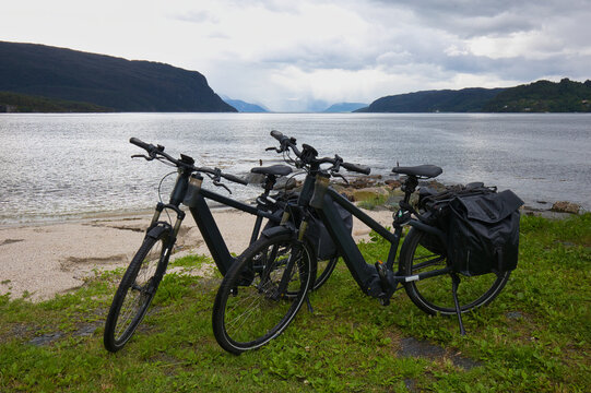 Two E-bikes on the shores of the Hardangerfjord in Norway.