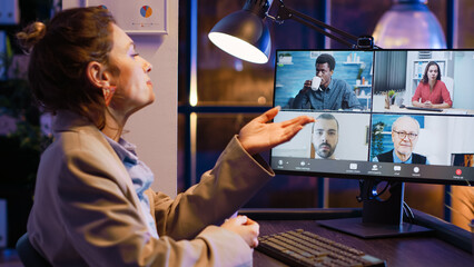 Fototapeta na wymiar Entrepreneur attending business meeting on video call talking to colleagues about startup investment. Employee using online conference chat late at night, chatting on videoconference.