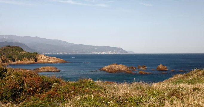 茶色い岩が点在する海の風景。