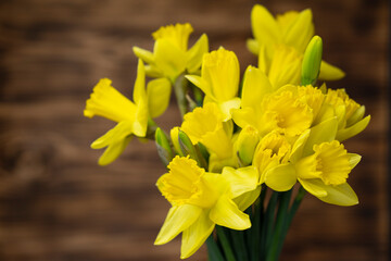 Obraz premium Yellow narcissus and daffodil on rustic wooden background, floral nature photography, Easter wallpaper