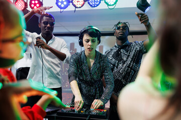 Dj and singers band energetic performance on stage at nightclub disco party. Energetic african...