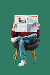 Young man reading newspaper in armchair on green background