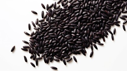 Heap of black rice grains on white background. Top view. Black rice texture. Suitable for food and nutrition related content. Ideal for use in culinary and health-related designs.
