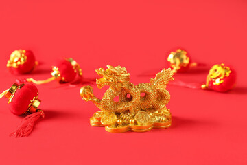 Golden dragon figurine with traditional paper lanterns on red background, closeup. Chinese New Year celebration