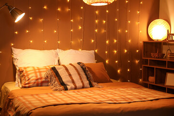 Interior of bedroom with glowing lights and lamps at night