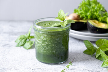 Blended green smoothie with ingredients. Healthy smoothie