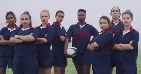 Women, sports and rugby with team, field and face with arms crossed for solidarity, power and diversity. Girl group, portrait and outdoor for competition, training and exercise for fitness on pitch