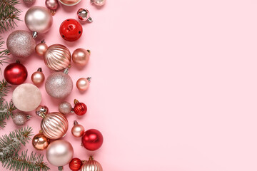 Christmas balls with fir twigs on pink background