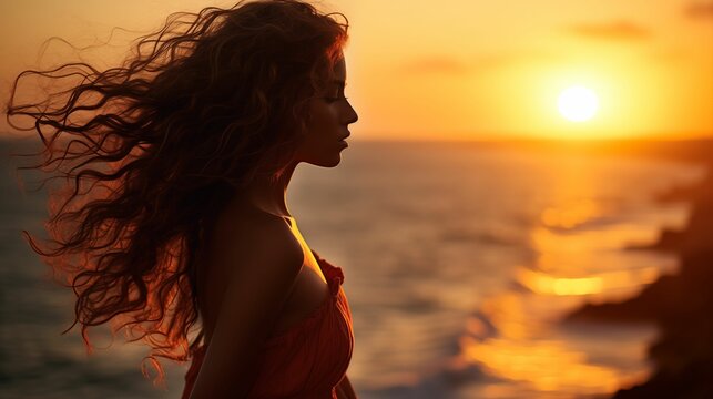 Image of a beautiful young girl against the backdrop of a vibrant sunset.