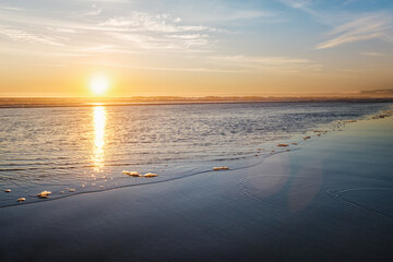 Fototapeta premium Atlantic ocean sunset with surging waves at Fonte da Telha beach, Costa da Caparica, Portugal