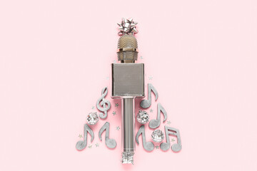 Christmas tree made of microphone, note signs and decorations on pink background