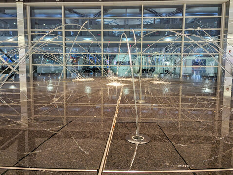 Detroit, MI - December 8 2023:  Fountain at the Detroit airport with a Delta plane in the background