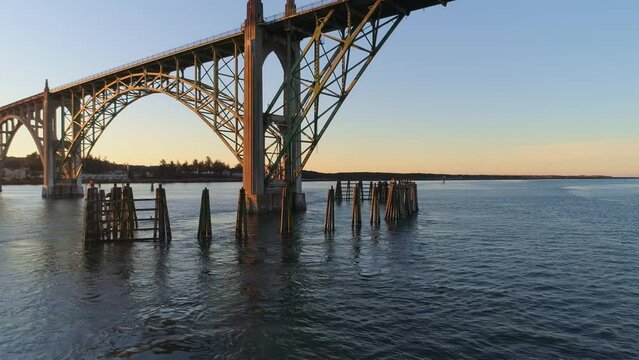 Aerial Drone Video- Yaquina Bay Bridge Sunrise- Newport Oregon-  Full backward reveal of bridge and bay - No boats V02