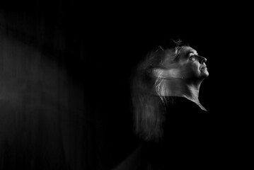 Black and white photo of woman performing in abstract performance with blurred movements.