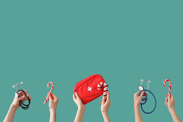 Hands holding medical equipment and Christmas decorations on green background - obrazy, fototapety, plakaty