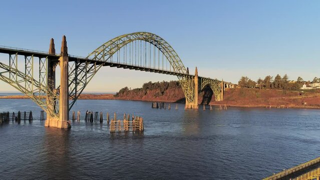 Aerial Drone Video- Yaquina Bay Bridge Sunrise- Newport Oregon-  Slow dolly-out reveal fishing pier V05