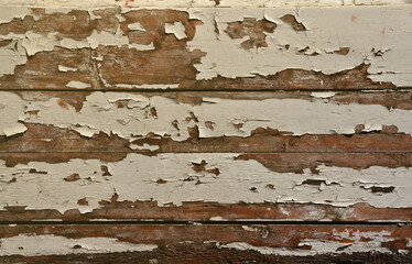 Texture of a wooden wall with an old paint coating that spoils under the influence of time and weather