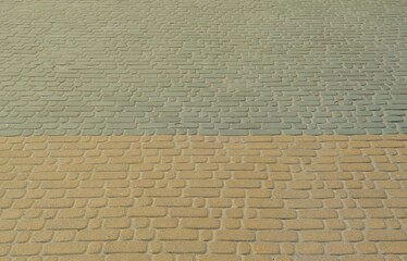 A detailed photo of the square, laid out of modern paving stone with rounded corners. Accurate...