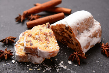 Tasty Christmas stollen on black background