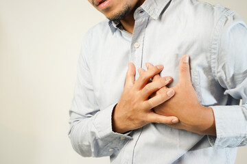 the man pressed his chest with a painful expression. Severe heartache, having a heart attack or...