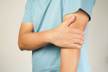 Health concept, person with elbow pain, man holding hand on elbow with pain, bone arthritis