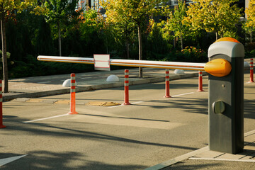 Closed boom barrier outdoors on sunny day © New Africa